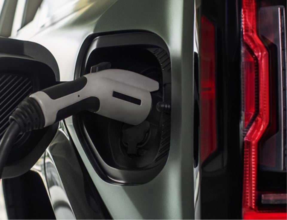 Close up of charging port with charger plugged in on a GMC Hummer EV SUV - Forest City Auto Center GMC in Forest City IA
