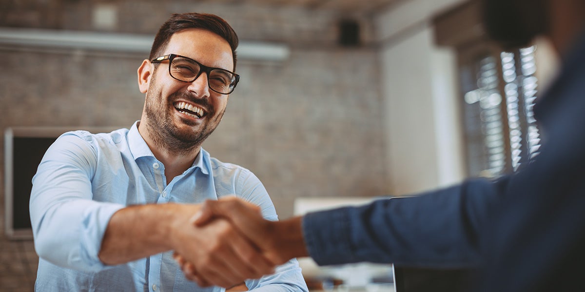 GMC car salesman greeting a new customer